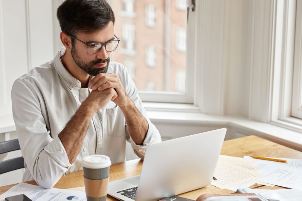 The man is concentrating at his computer