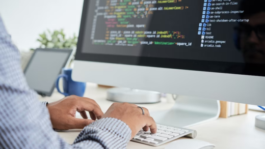 A man inputting code on his computer