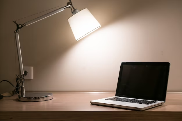 Lamp and laptop on table