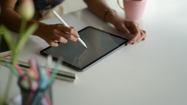 A woman using a stylus on her iPad