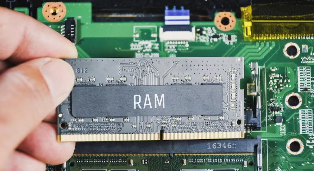 A hand holding a RAM module