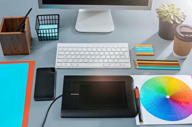 Work desk with computer, notepad and design tablet