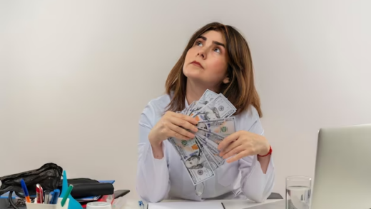 Girl holding money in her hands and look up