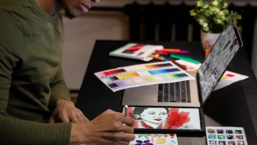 Side view of a man drawing on a tablet