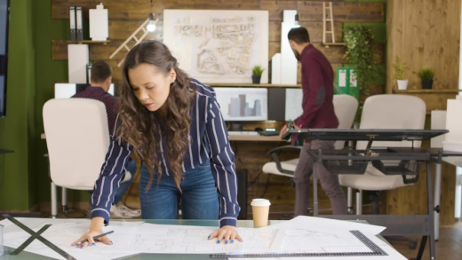 Designer Working on Blueprints in Office