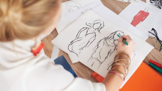 A woman designer draws a new sketch for a clothes