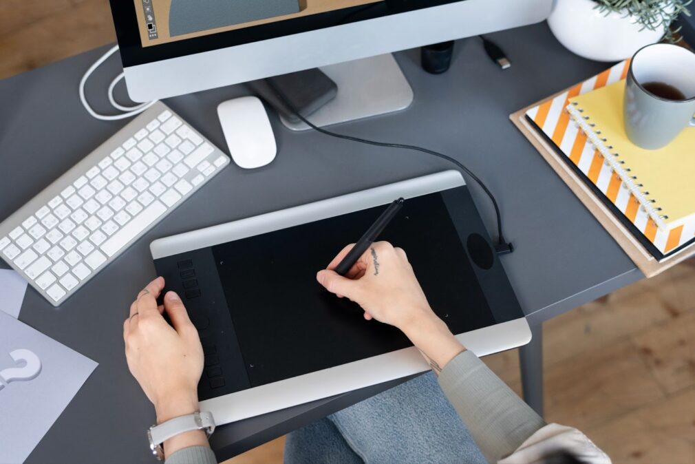 A woman using a tablet to work on a design