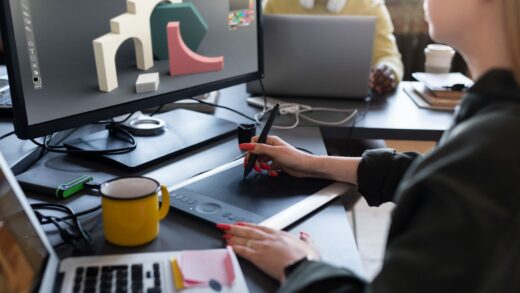 A woman works on a design using a tablet